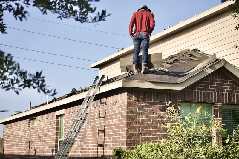 Professional roofer working on a residential roof in Island Lake